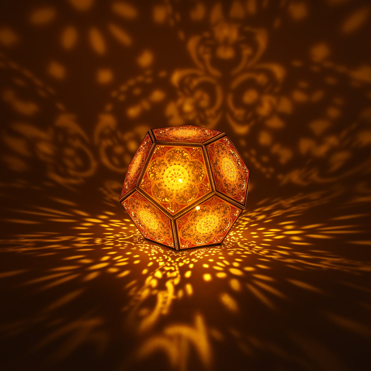 MikhaLuma Logos dodecahedron lantern in Amber style, lit with a warm amber tone