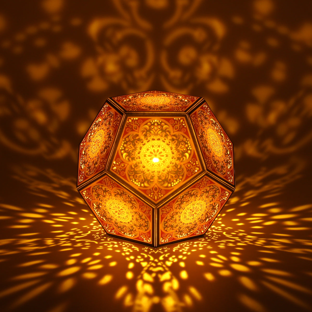 MikhaLuma Logos dodecahedron lantern in Amber style, lit with a warm amber tone