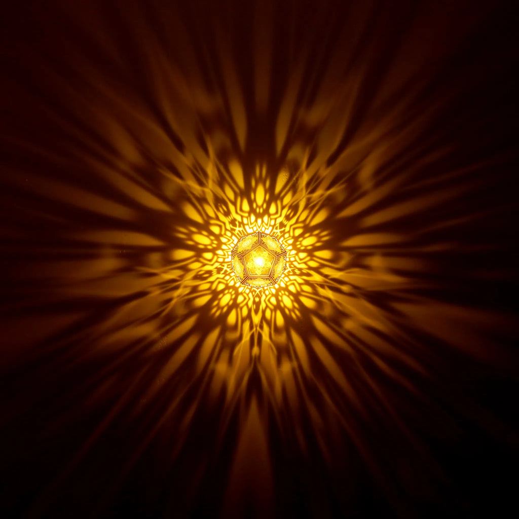 MikhaLuma Telos dodecahedron lantern in Amber style, warm amber light washing a wall