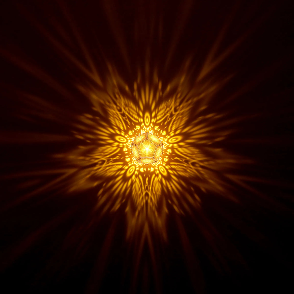 MikhaLuma Storge dodecahedron lantern in Amber style, warm amber light washing a wall