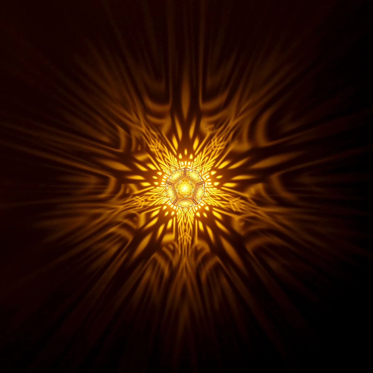 NEEDS REPLACING: this is an Arete photo on the Episteme product. MikhaLuma Arete dodecahedron lantern in Amber style, warm amber light washing a wall