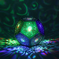 MikhaLuma Episteme dodecahedron lantern in Shadow Caster style, casting geometric light patterns across a dark room