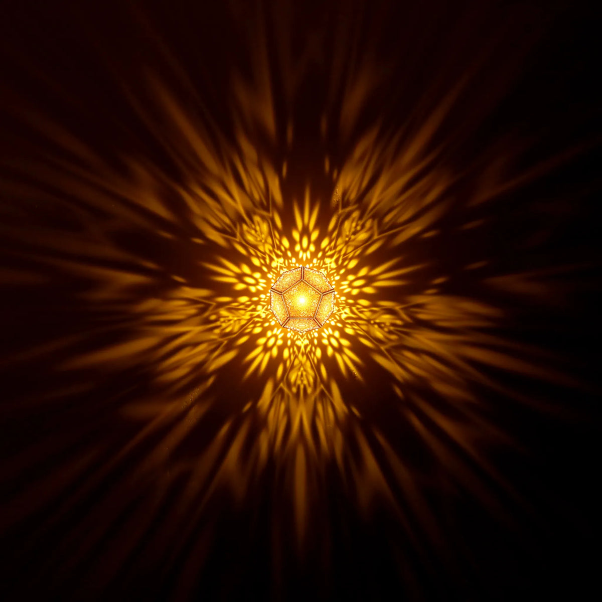 MikhaLuma Eudaimonia dodecahedron lantern in Amber style, warm amber light washing a wall