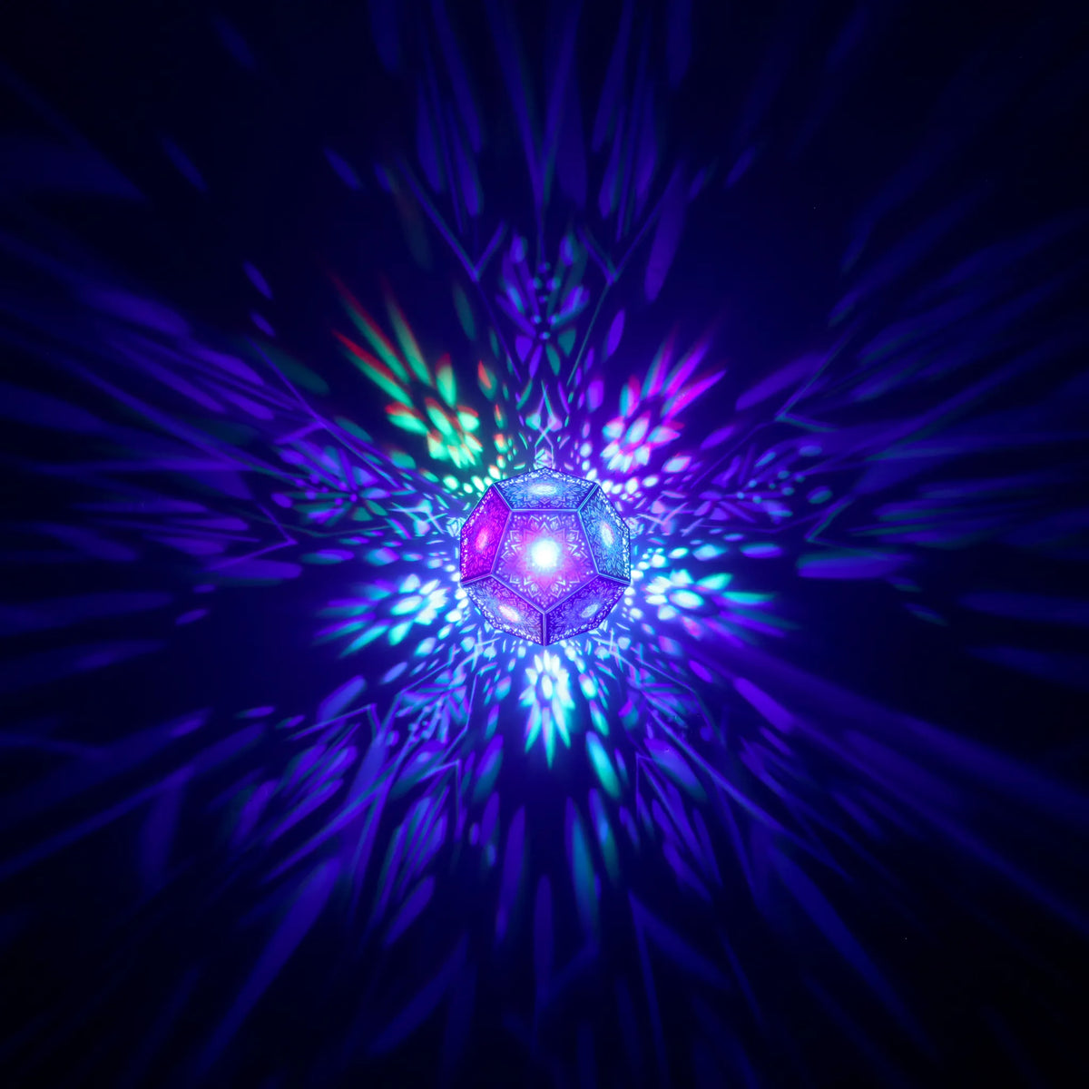 MikhaLuma Eudaimonia dodecahedron lantern in Shadow Caster style, geometric pattern projected across a wall