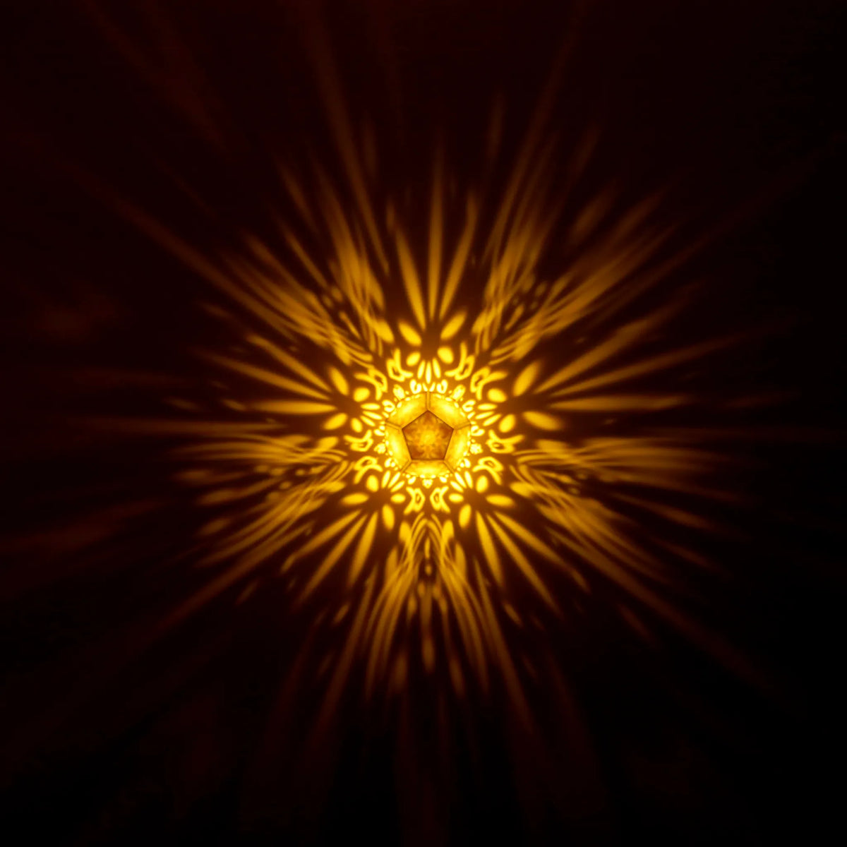 MikhaLuma Ataraxia dodecahedron lantern in Amber style, warm amber light washing a wall