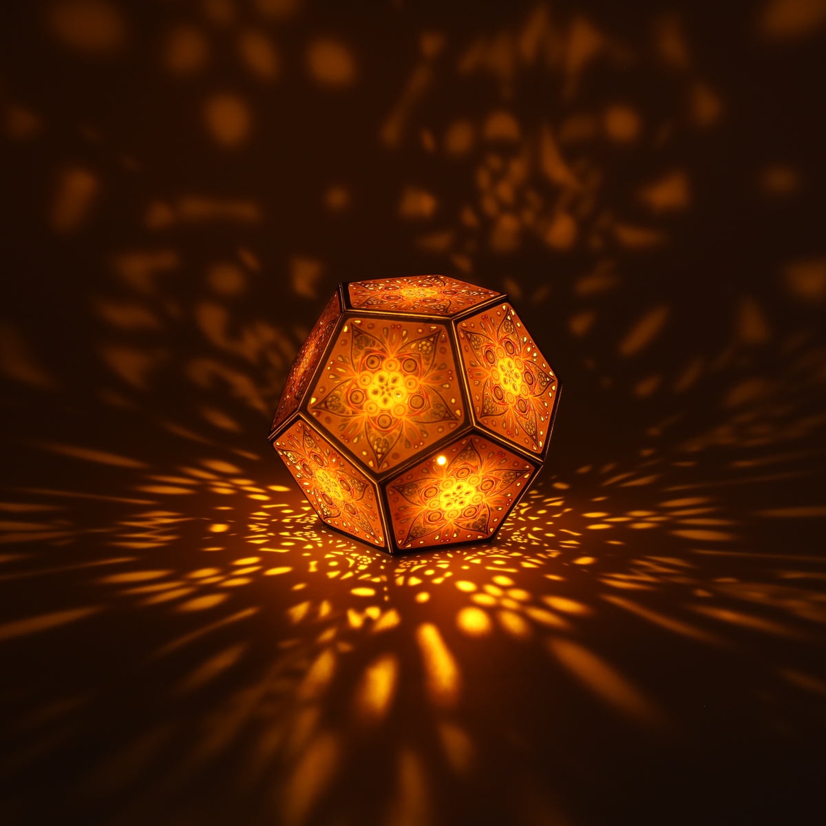 MikhaLuma Phronesis dodecahedron lantern in Amber style, lit with a warm amber tone