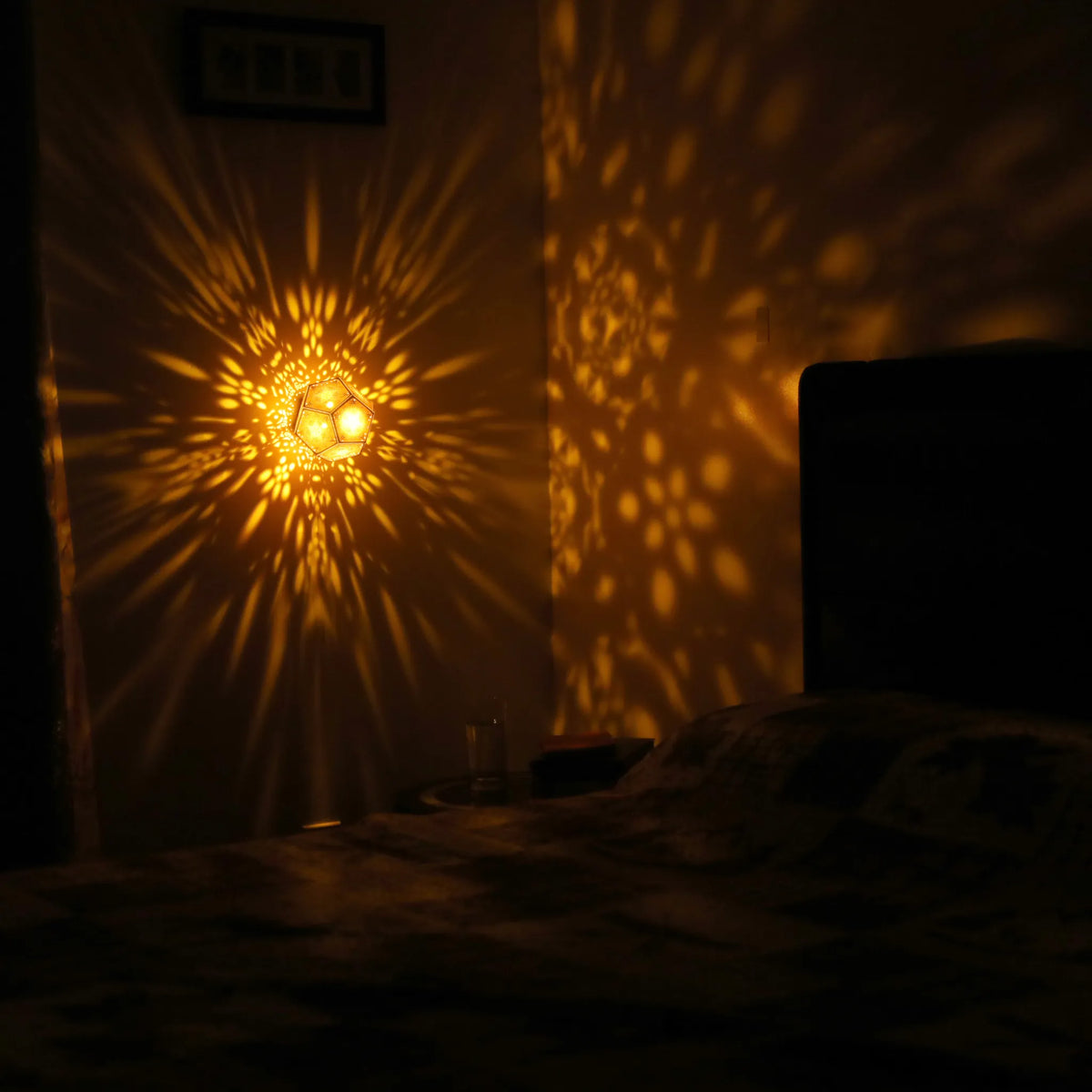 MikhaLuma Phronesis dodecahedron lantern in Amber style, warm amber light wrapping a wall corner