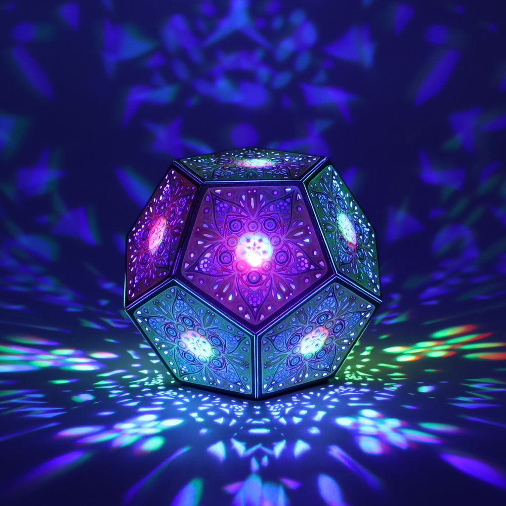 MikhaLuma Phronesis dodecahedron lantern in Shadow Caster style, casting geometric light patterns across a dark room