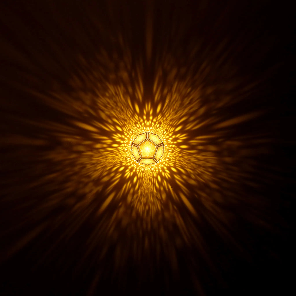 MikhaLuma Eros dodecahedron lantern in Amber style, warm amber light washing a wall
