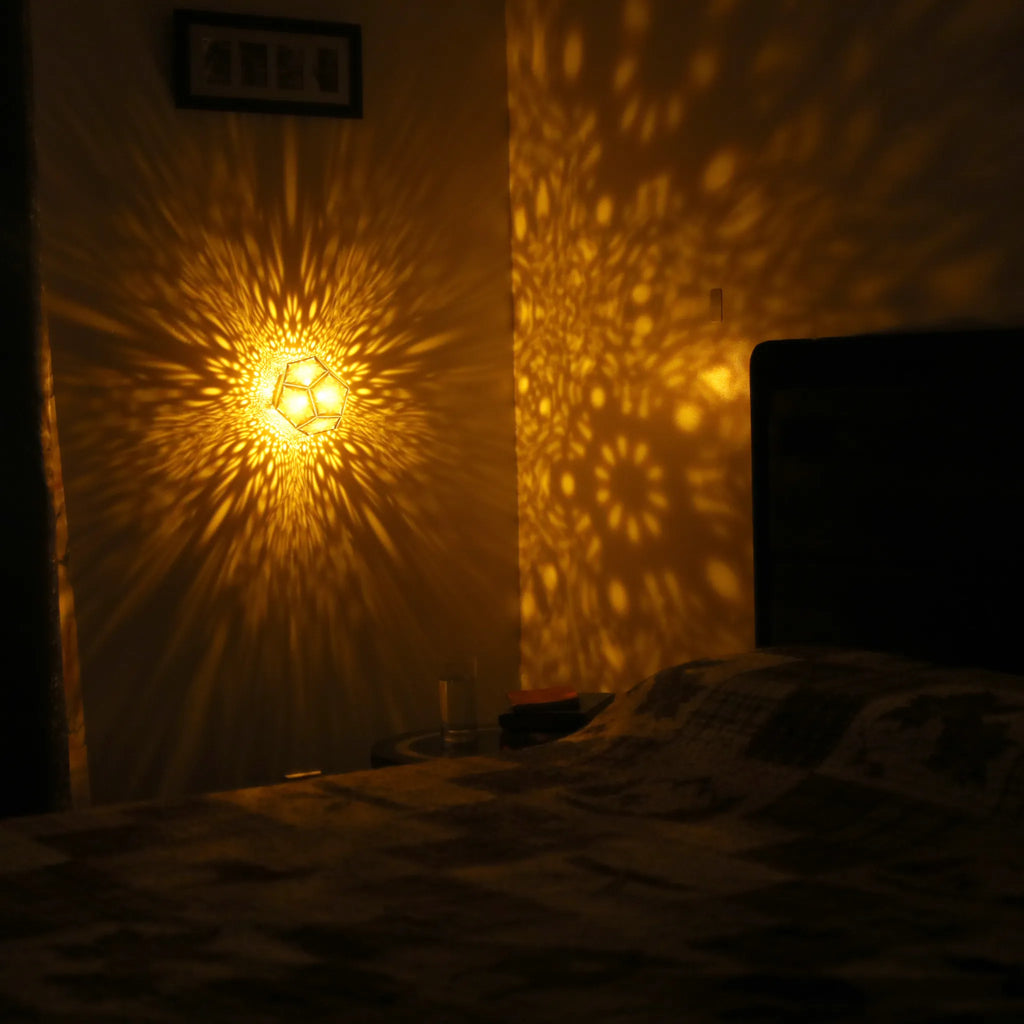 MikhaLuma Eros dodecahedron lantern in Amber style, warm amber light wrapping a wall corner