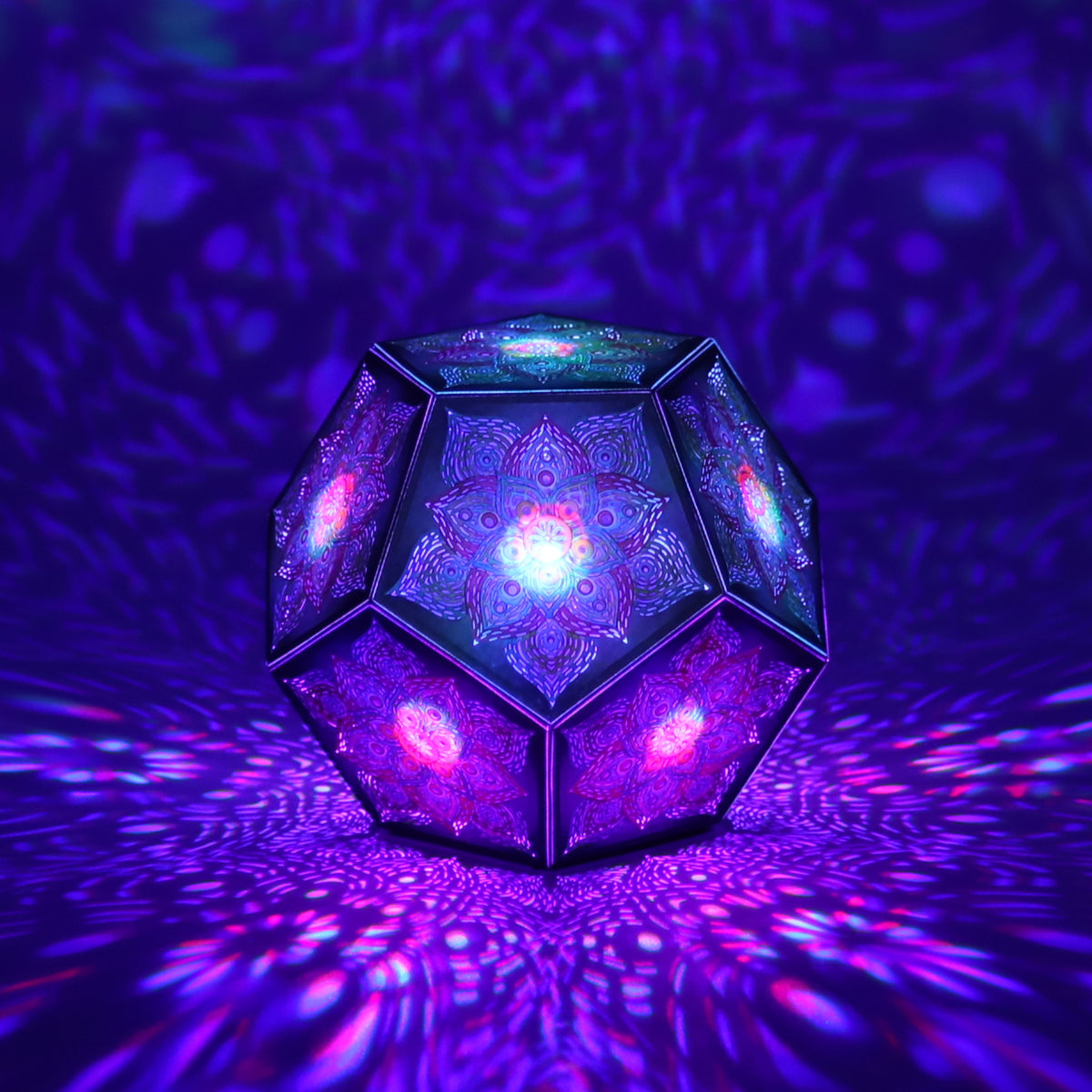 MikhaLuma Eros dodecahedron lantern in Shadow Caster style, casting geometric light patterns across a dark room