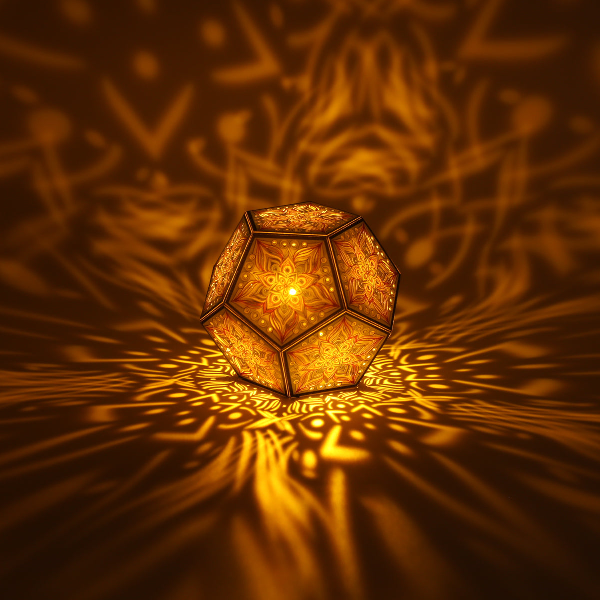 MikhaLuma Metanoia dodecahedron lantern in Amber style, lit with a warm amber tone