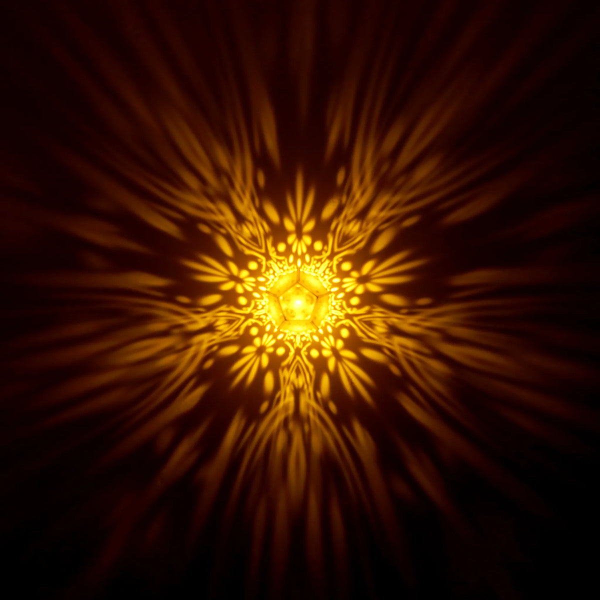 MikhaLuma Agape dodecahedron lantern in Amber style, warm amber light washing a wall