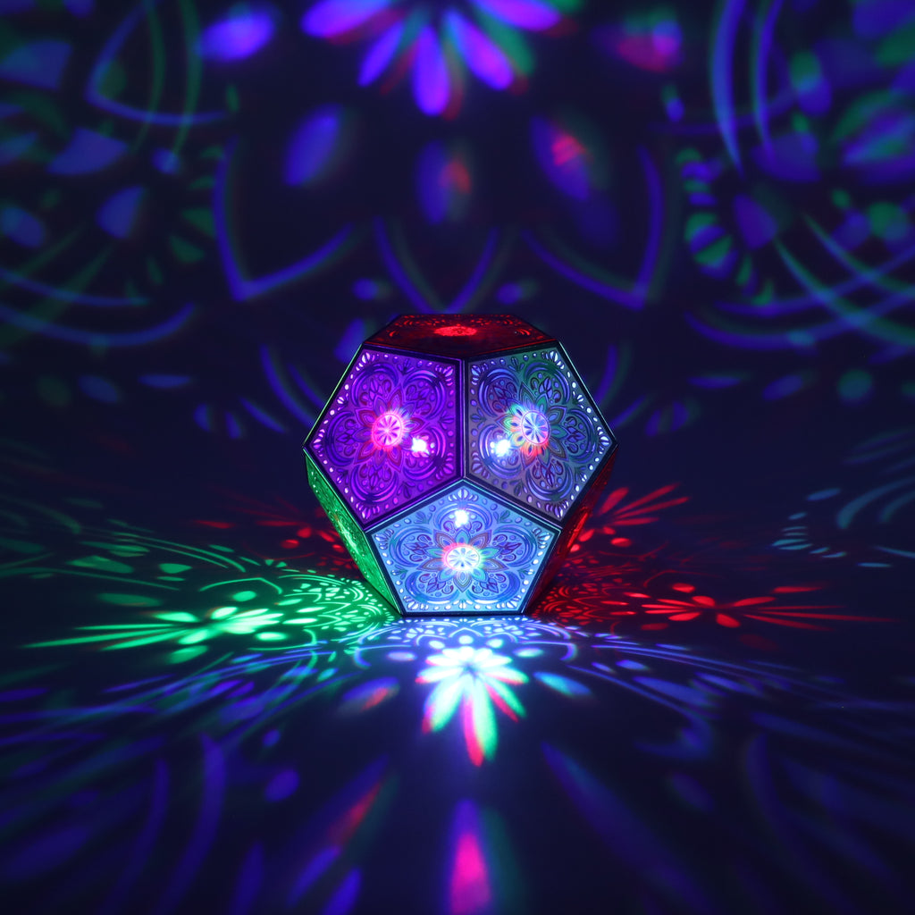 MikhaLuma Agape dodecahedron lantern in Shadow Caster style, casting geometric light patterns across a dark room