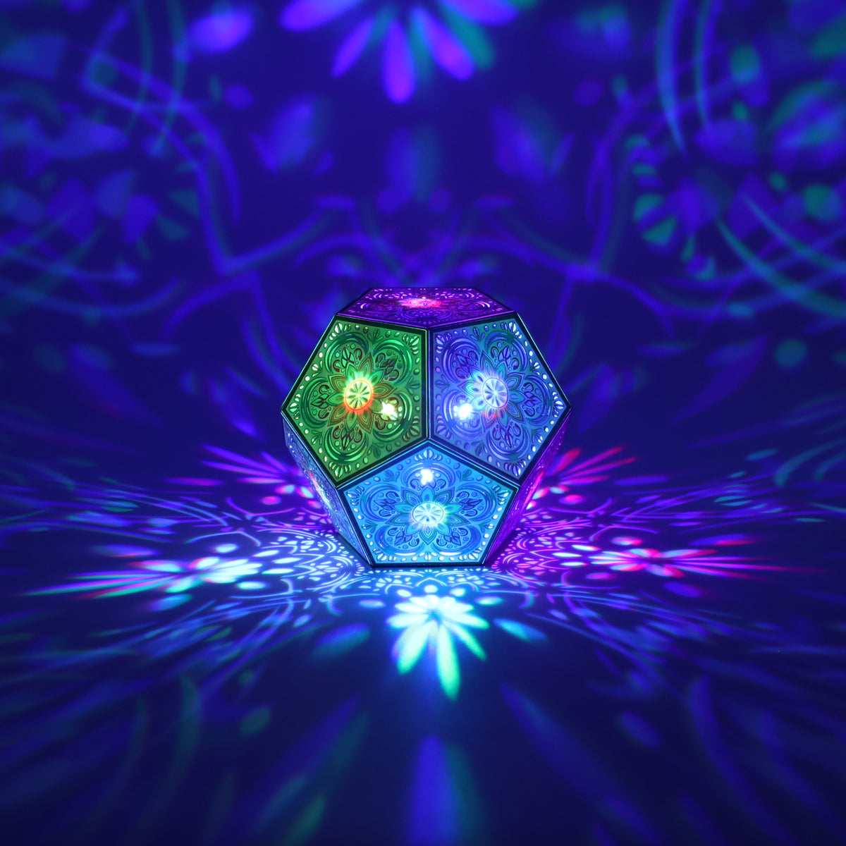MikhaLuma Agape dodecahedron lantern in Shadow Caster style, casting geometric light patterns across a dark room